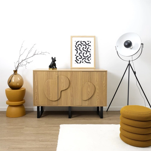 Komoda Calypso dub artisan s dekorativními čely na černých nohách 120 cm do boho obýváku